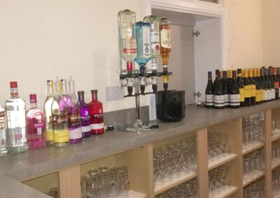 Dumbleton Village Hall bar area with stock